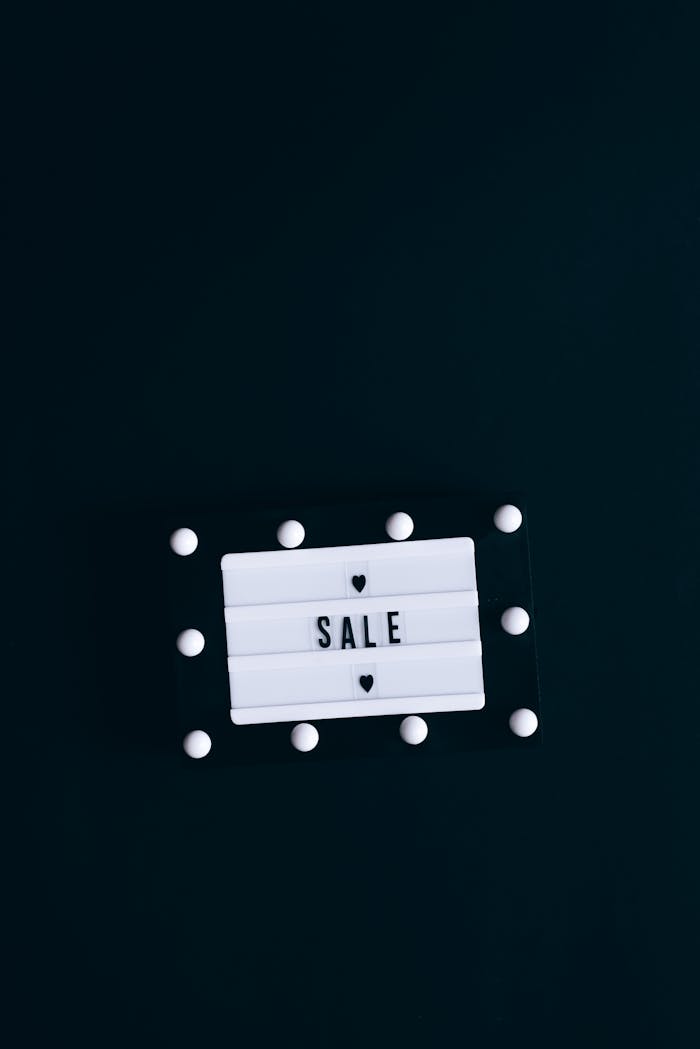 A minimalist lightbox sign displaying SALE against a dark backdrop, perfect for promotions.