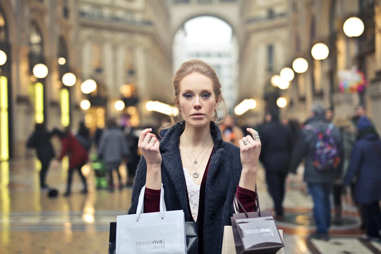 Elegant woman shopping with bags in Milans iconic Galleria Vittorio Emanuele II.